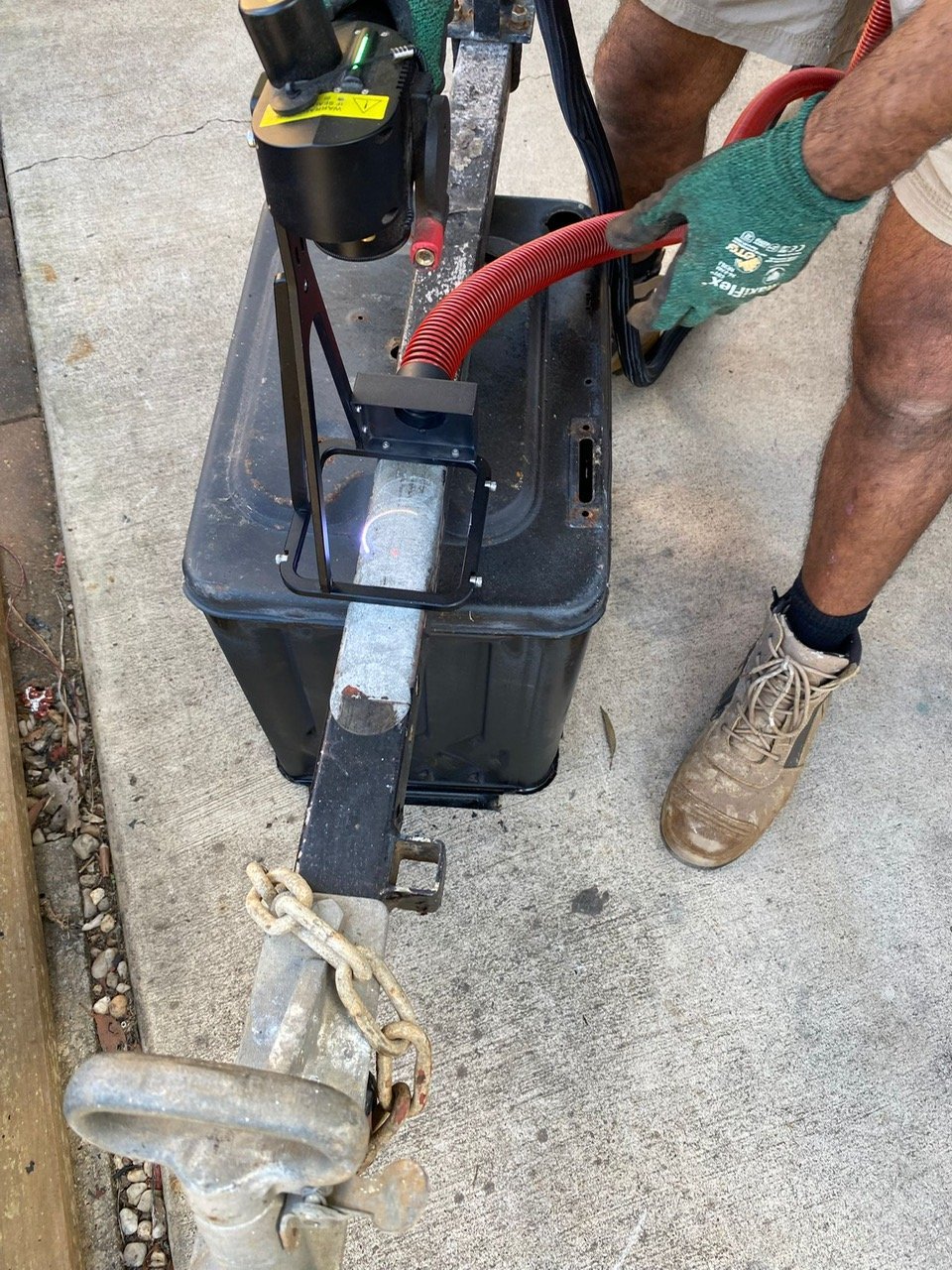 Vacuum hose capturing debris at the laser head